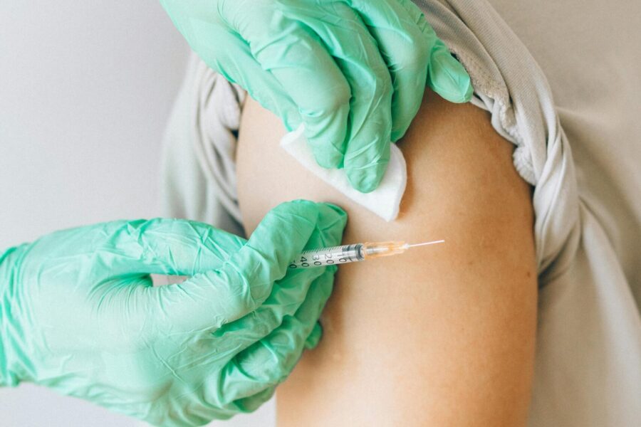A picture of an arm being vaccinated