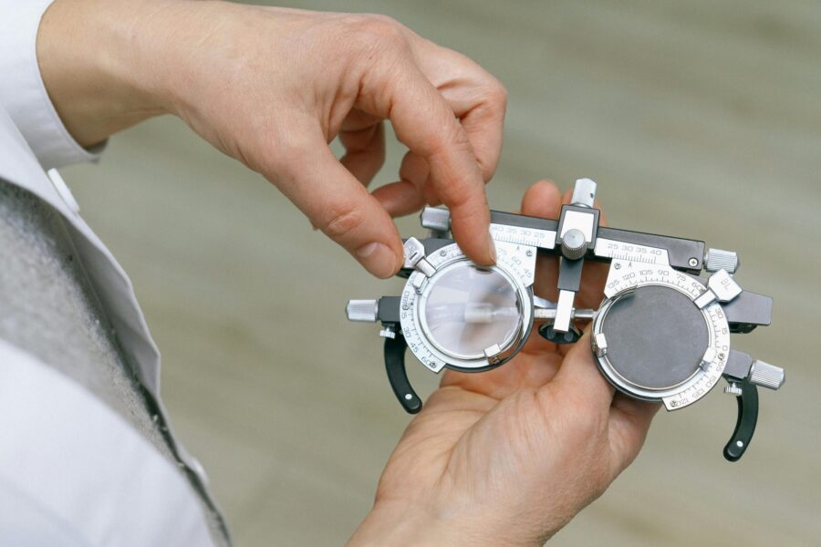 A picture of hands holding an optician's testing piece